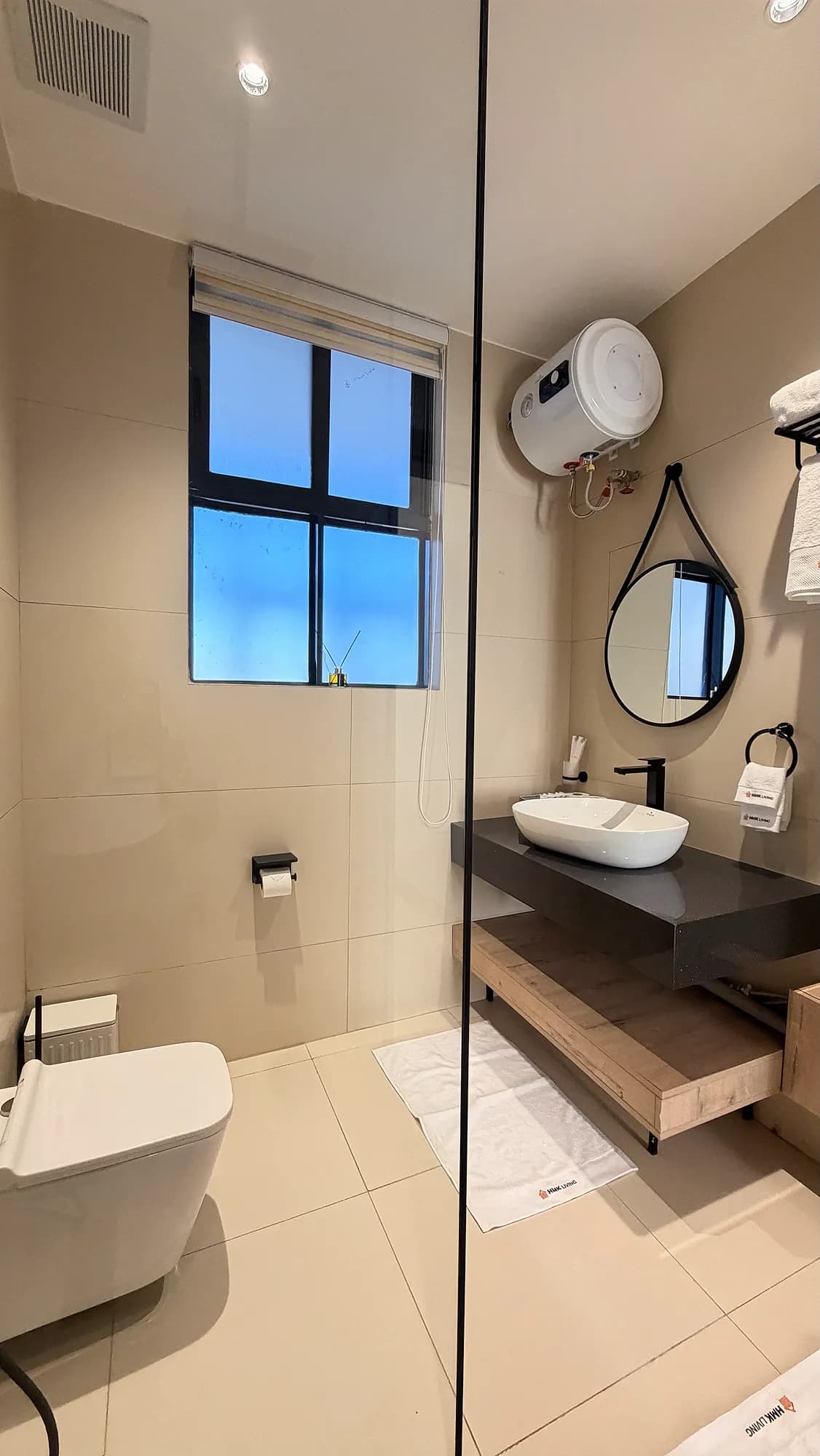 HMK Living ensuite bathroom with vessel basin and window, Kigo Kampala