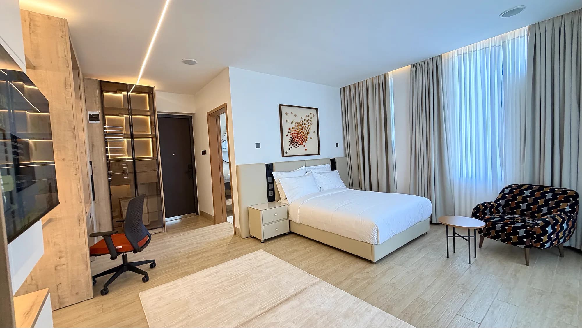 Studio Deluxe with bed, writing desk and full-height window, Kigo Kampala